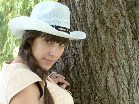 Young brunette girl walks in the park