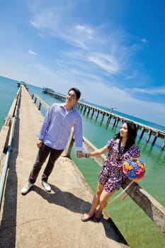 young bride and groom on fisherman pier with beautiful sky