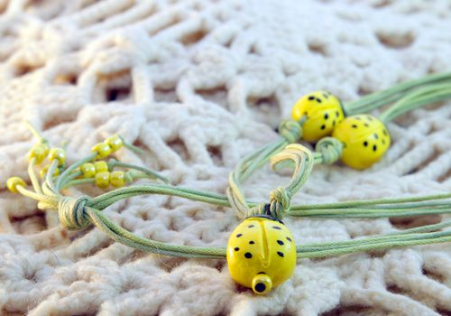 clay handmade yellow ladybirds on a knitted background