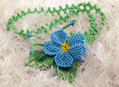 clay handmade blue bead pendant flower on a white background