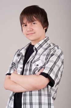 portrait of teen boy, gray background gray