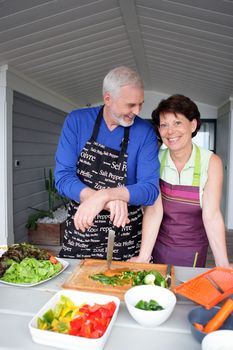 Couple preparing vegetables