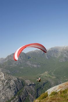 Picture of paraglider taking off in mountanis in Lysefjord, Norway.