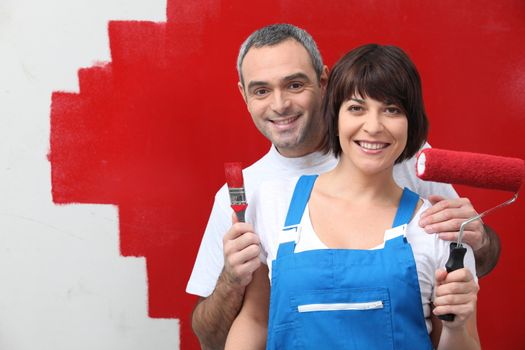 Couple painting their house