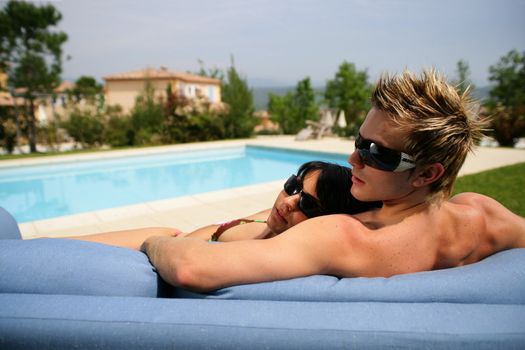 Couple relaxing by the pool