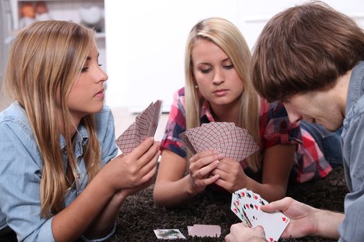 portrait of teenagers playing cards