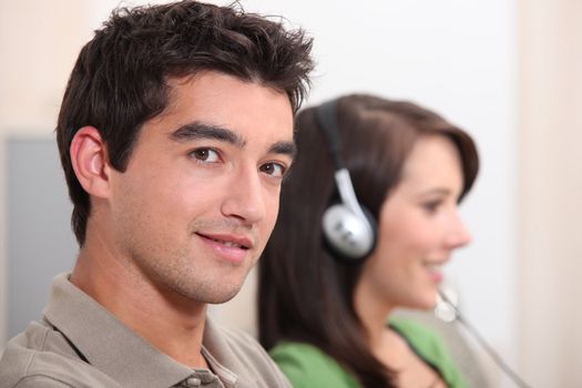 Woman listening to music next to her boyfriend