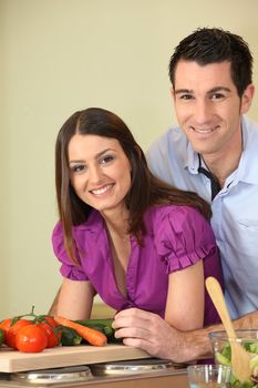 Young couple cooking in kitchen