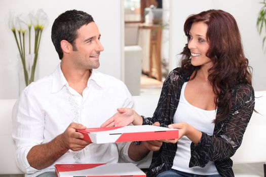 Couple eating take-away pizza