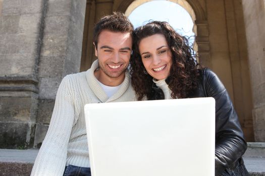 couple sitting with a laptop