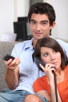 Couple relaxing in front room at home