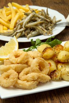 a dish with different fish fried and potate