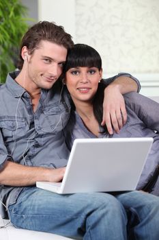 couple listening music on the couch