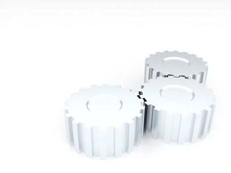 Three linked metal silvery gears on a white background