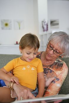 Young child reading with grandma