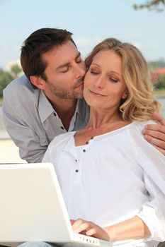 Man kissing a woman tenderly on the cheek