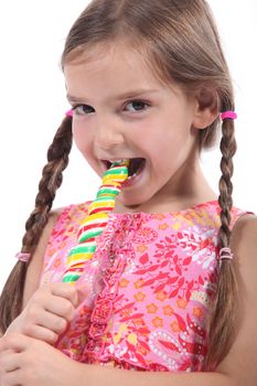 little girl with plaits sucking lollipop
