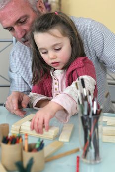 grandfather playing with his granddaughter