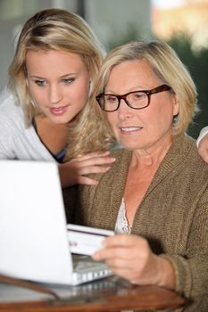 grandmother with granddaughter paying online