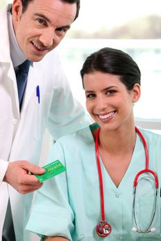 doctor and nurse taking care of patient's health insurance
