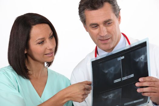 Nurse and radiologist watching x-ray
