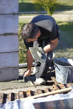 Mason with trowel and cement