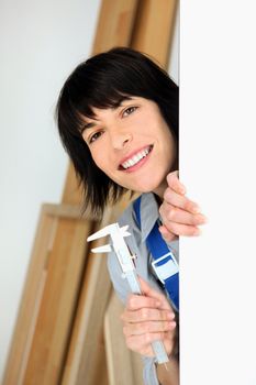 Handywoman holding callipers