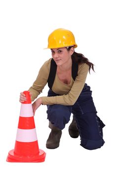 Woman kneeling by traffic cones