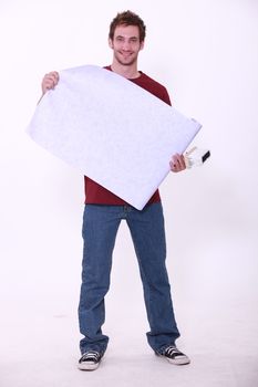Handyman with wallpaper and glue brush
