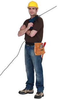 Worker with a masonry drill