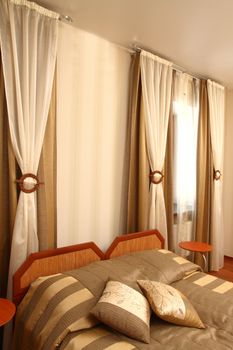 fragment of an interior of a bedroom. two beds and two pillows, on a background a window, a vertical shot