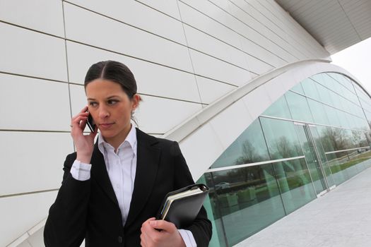 Businesswoman on a cellphone outside an office building