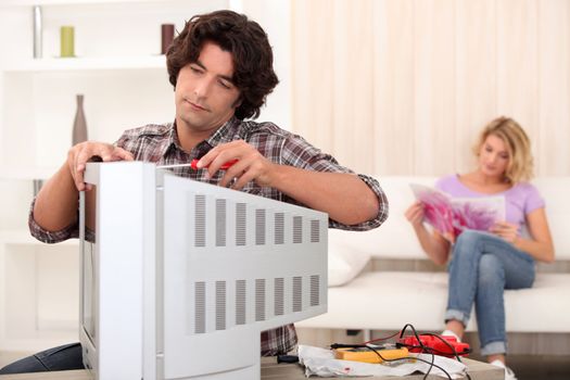 technician repairing a television