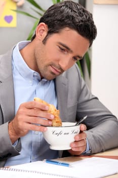 Young man having breakfast