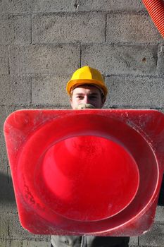 Builder holding traffic cone