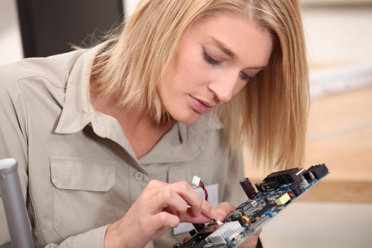 woman repairing electronic piece