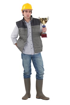 Builder proudly holding trophy