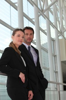 Serious businesspeople standing in hallway