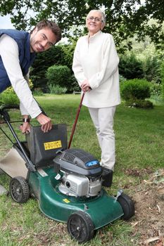 Senior with gardener and lawnmower