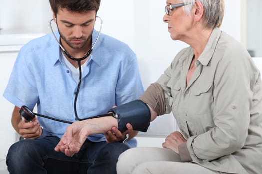 Doctor taking the blood pressure of a patient