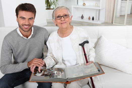 Elderly person looking at photos with son