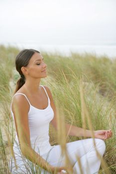 Woman doing yoga in a field