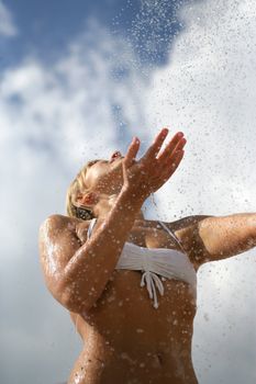 Woman splashing water on herself