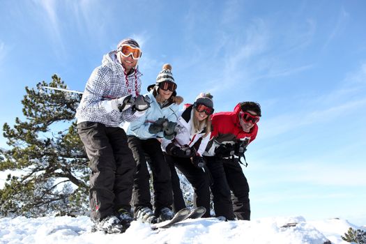 Four friends skiing together on holiday