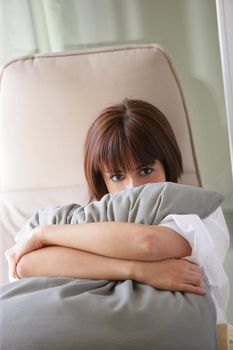 Woman hugging a cushion