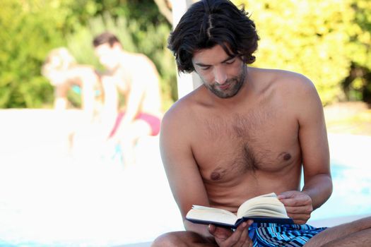 Man reading by the pool