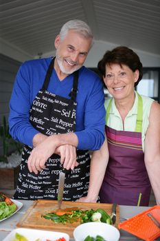 Older couple preparing an outdoor lunch