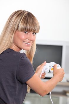 Young woman with a games console handset