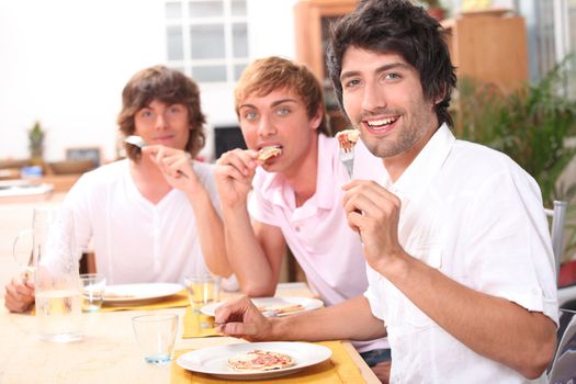 Three friends enjoying outdoor meal together