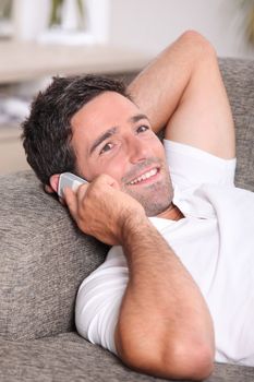 Closeup of a man talking on the telephone at home
